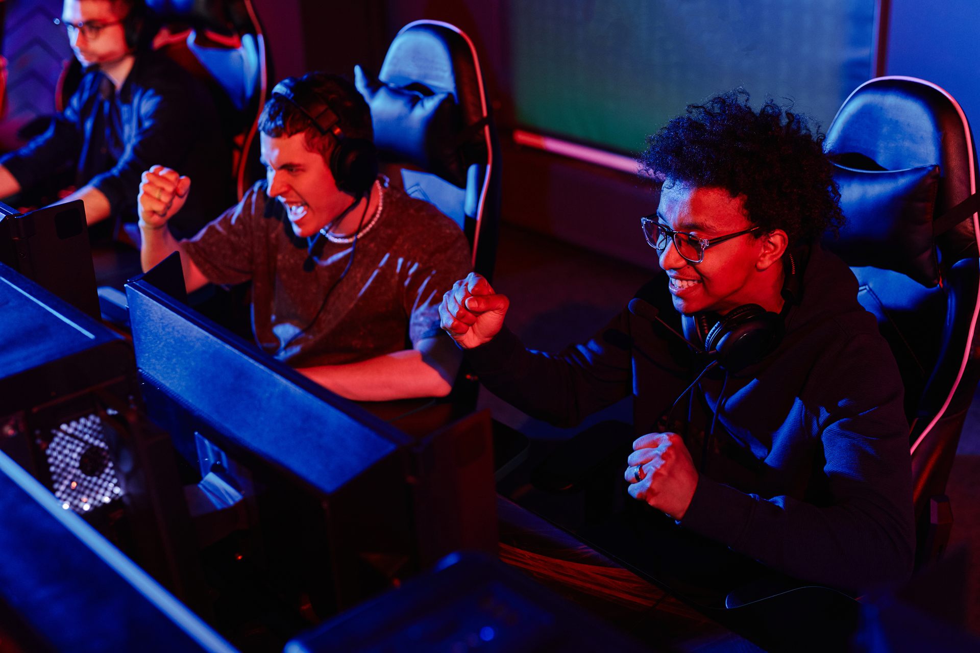 Esports team cheering a triumphant victory at a gaming event